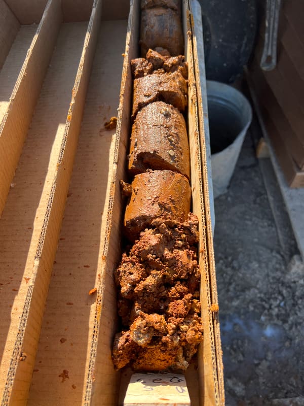Wooden tray holding a run of freshly recovered sanded dolomite core